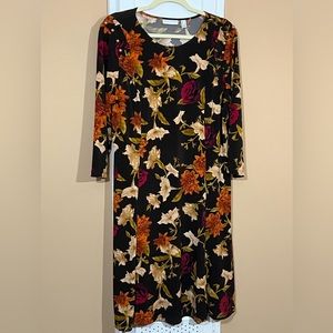 Susan Graver Liquid Knit Floral Print on Dark Chocolate background